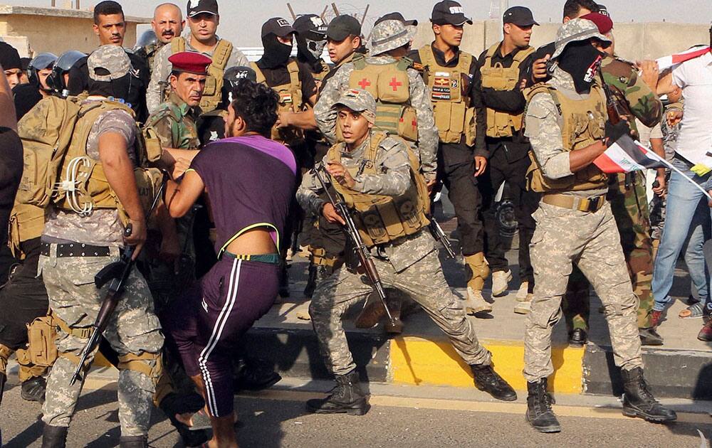 Iraqi riot police prevent jobless Iraqis from storming a complex of foreign oil companies during a demonstration demanding jobs Iraqi riot police prevent jobless Iraqis from storming a complex of foreign oil companies during a demonstration demanding jobs