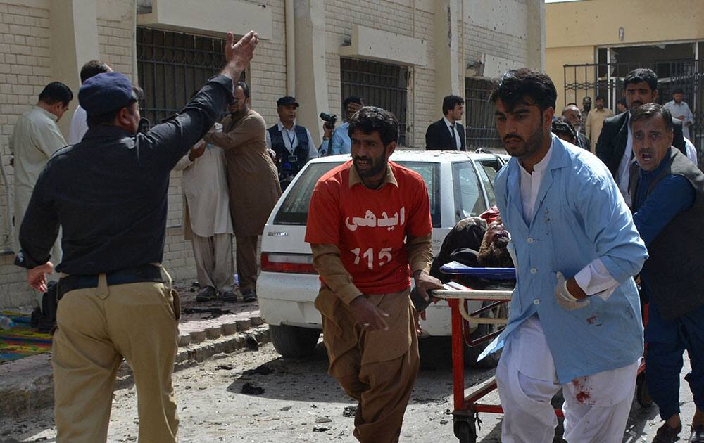 Pakistani volunteers rush an injured person for medical help following a bomb blast in Quetta, Pakistan Pakistani volunteers rush an injured person for medical help following a bomb blast in Quetta, Pakistan