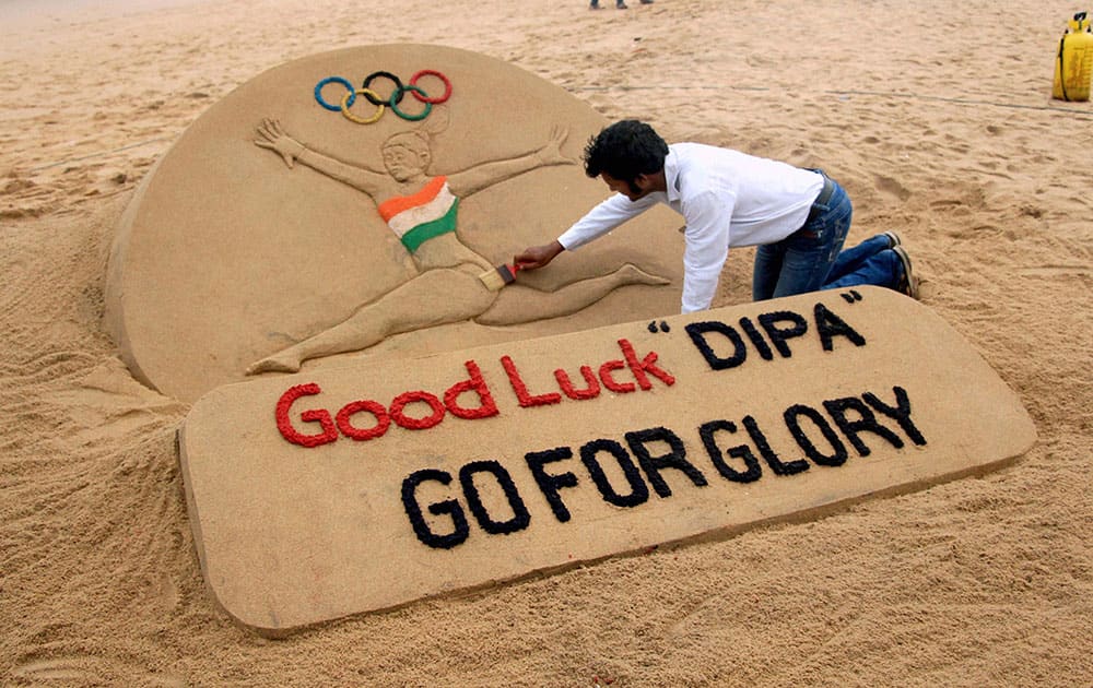 Sand artist Sudarsan Pattnaik creates a sand sculpture on Deepa Karmakar for entering into the final round in artistic gymnastic at Rio Olympic 2016