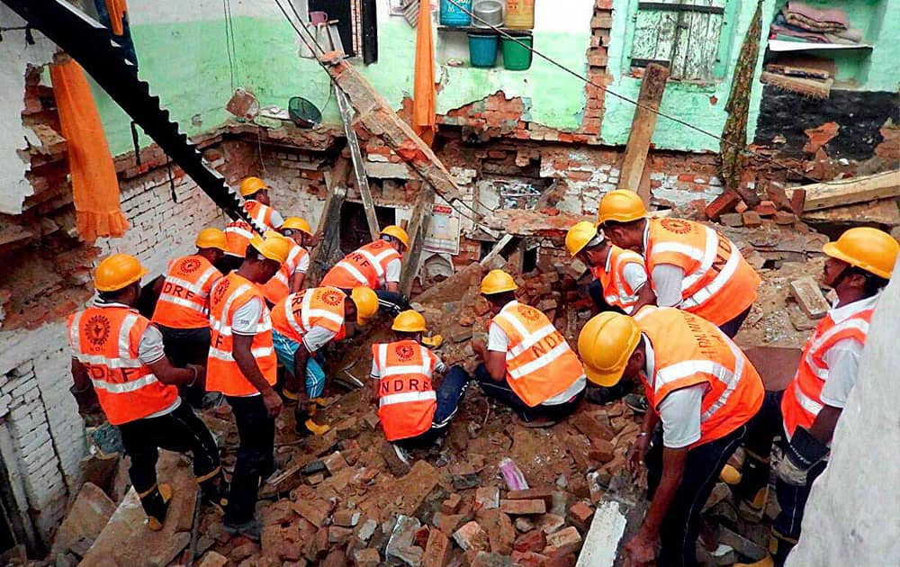 Army and NDRF personnel carry out rescue operations after a two-storey building collapsed in Varanasi