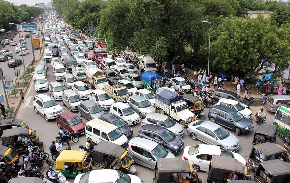 Vehicles wait in long ques due to in heavy traffic jam in the roads of Gurgaon