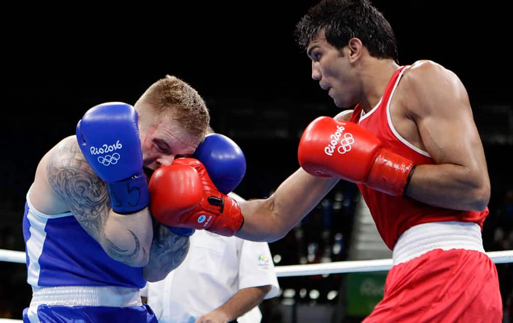 India's Manoj Kumar fights Lithuania's Evaldas Petrauskas during a men's light welterweight 64-kg preliminary boxing match