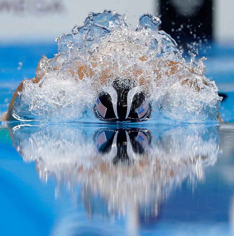 gold medal winner Michael Phelps competes in the men's 200-meter individual medley final during the swimming competitions