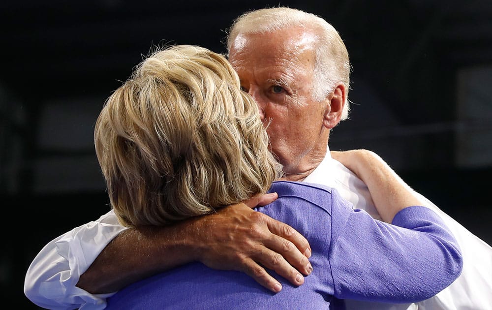 Vice President Joe Biden kisses Democratic presidential candidate Hillary Clinton embrace during a campaign event at Riverfront Sports in Scranton, Pa.