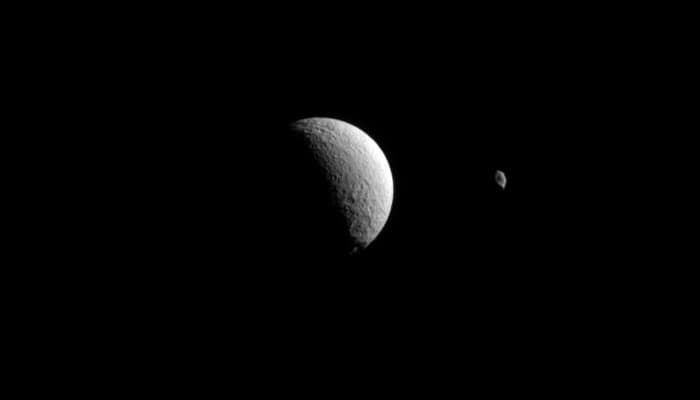 Tethys and Hyperion - Saturn&#039;s distant moons appear close in this Cassini view! (See pic)