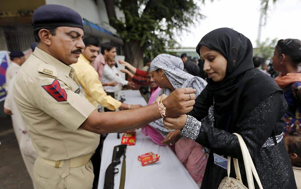 Muslim women tying Rakhi