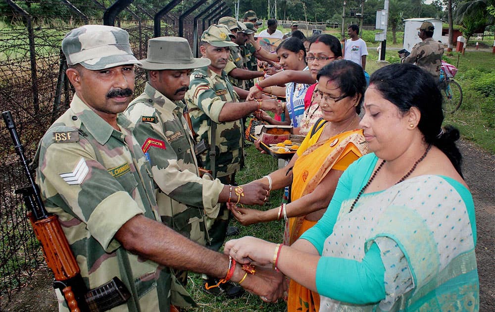 Women tying rakhis on the wrists of Border Security Force (BSF) jawans