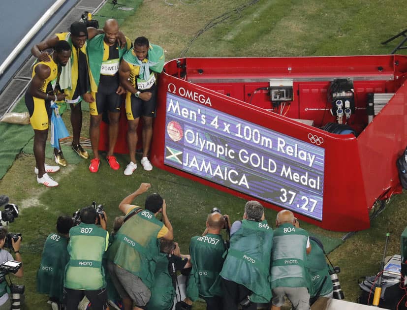 Jamaicas 4 x 100 meter team celebrates after winning Jamaicas 4 x 100 meter team celebrates after winning