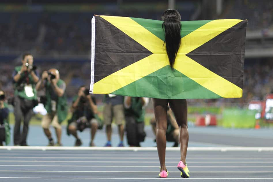 Jamaica's Elaine Thompson celebrates winning the gold meda