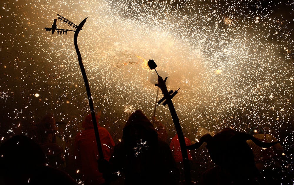 Revelers hold fireworks as they take part in 