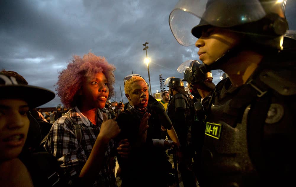 Students argue with the police during a protest against the money spent on the Rio 2016 Olympics in Rio de Janeiro, Brazil