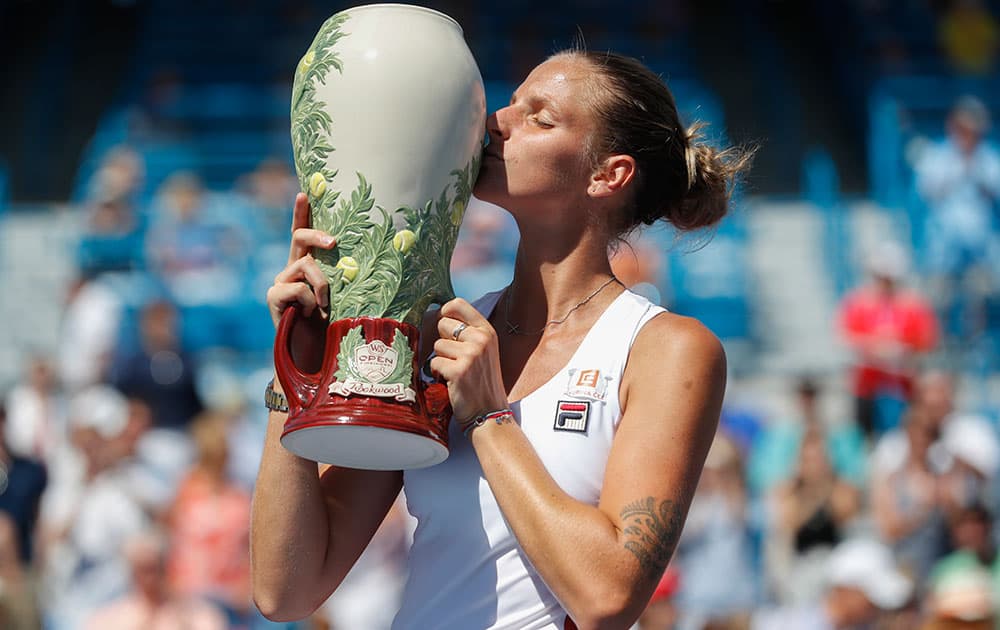 Karolina Pliskova, of the Czech Republic, kisses the Rookwood Cup after defeating Angelique Kerber, of Germany, during the finals of the Western & Southern Open tennis tournament