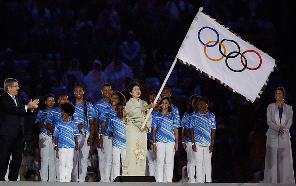 Tokyo Governor Yuriko Koike waves the Olympic flag