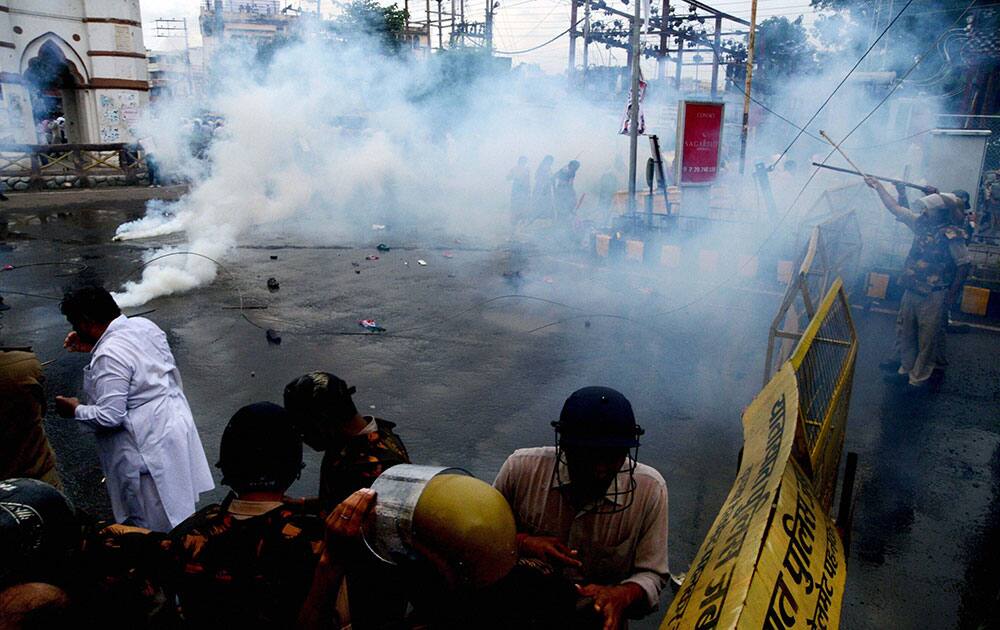 Police use teargas shells and gas bombs to disperse Congress supporters who were holding a protest against Madhya Pradesh and Union governments