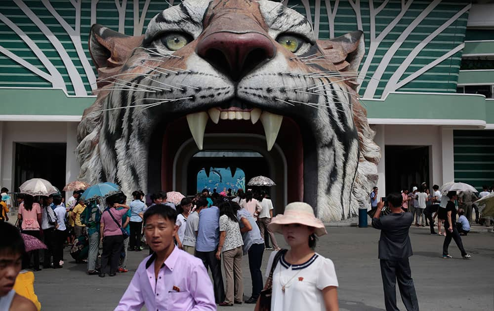 North Koreans wait at the gate of the newly opened Pyongyang Central Zoo in Pyongyang, North Korea