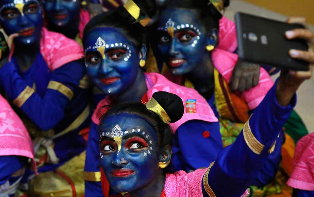 students who got their faces painted in blue color take a selfie ahead of Janmashtami celebrations at a college in Mumbai