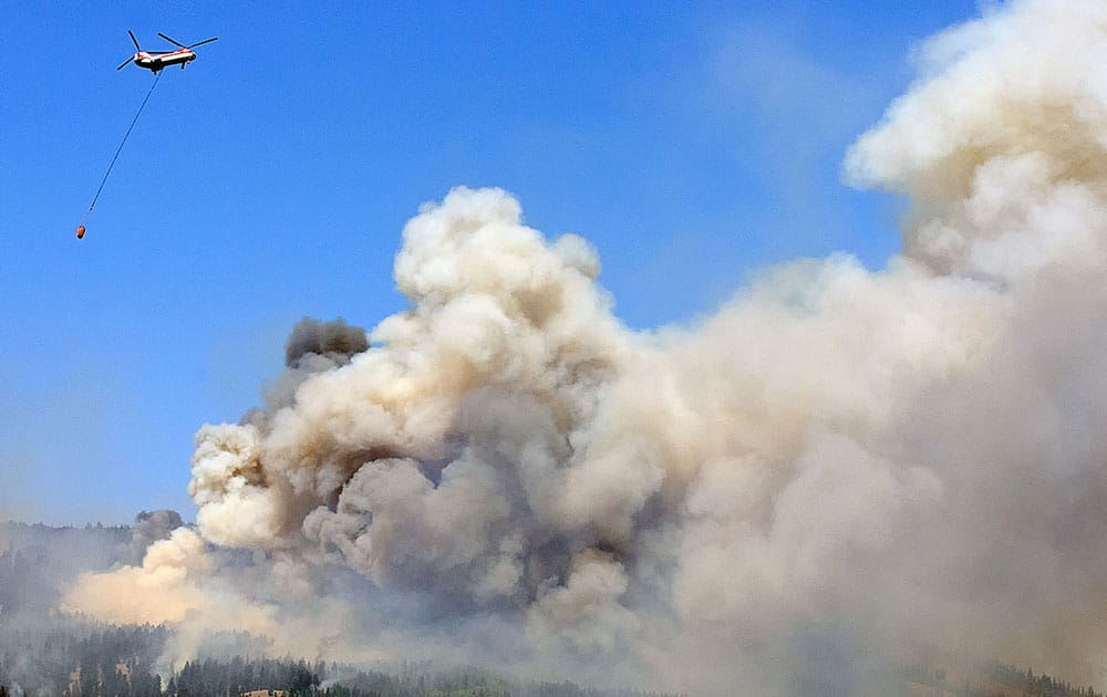 Firefighters battle a wildfire near Garden City, Utah