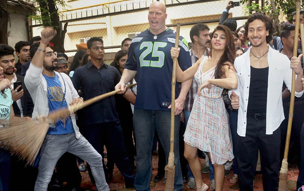 Nathan Jones, Jacqueline Fernandez and Tiger Shroff wield brooms at Welingkar Institute during promotion of the film A Flying Jatt in Mumbai