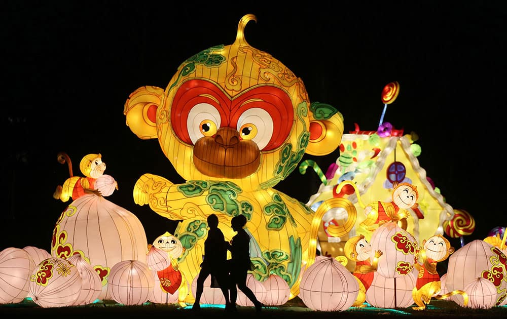 People walk past illuminate Chinese sculptures during the European premiere of the China Lantern Festival in Vienna, Austria