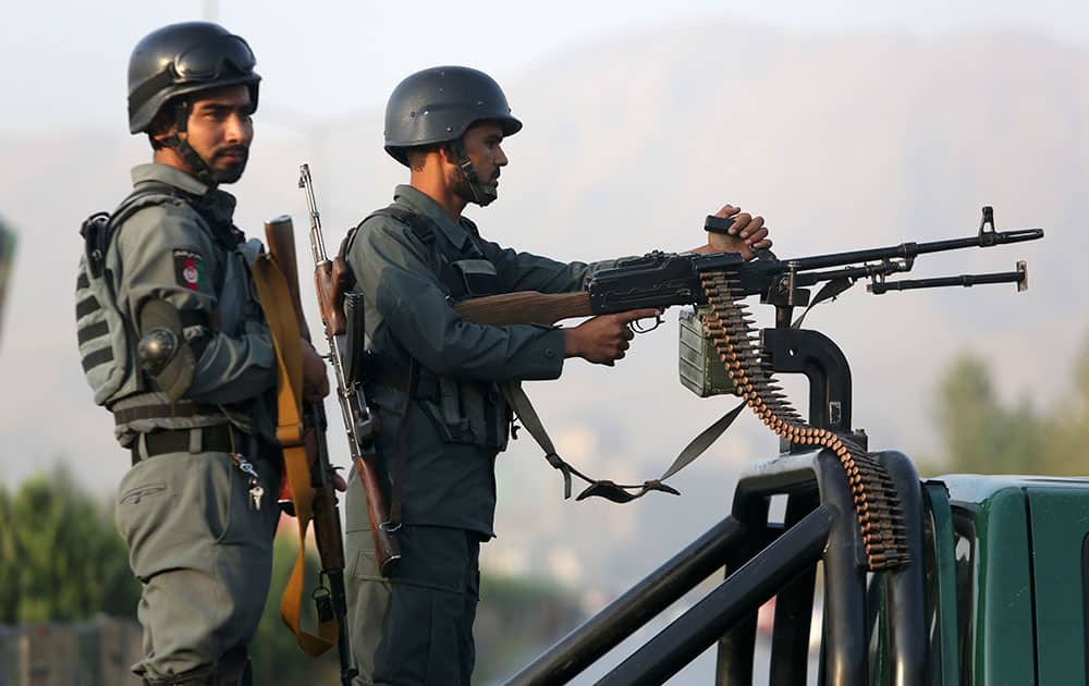 Afghan security forces stand guard after an attack on the American University of Afghanistan