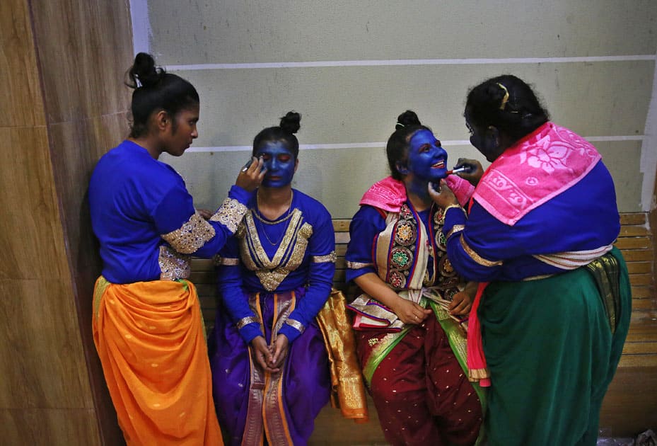 Indian students get their faces painted in blue color