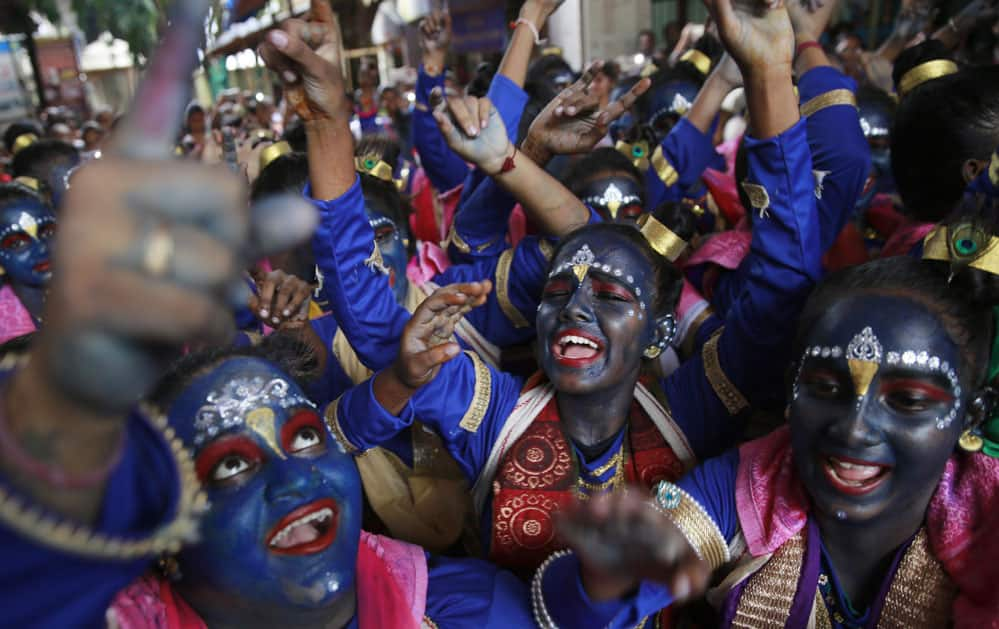 faces painted in blue color cheer during Janmashtami