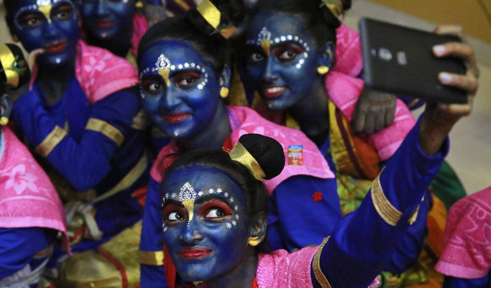 students who got their faces painted in blue color take a selfie