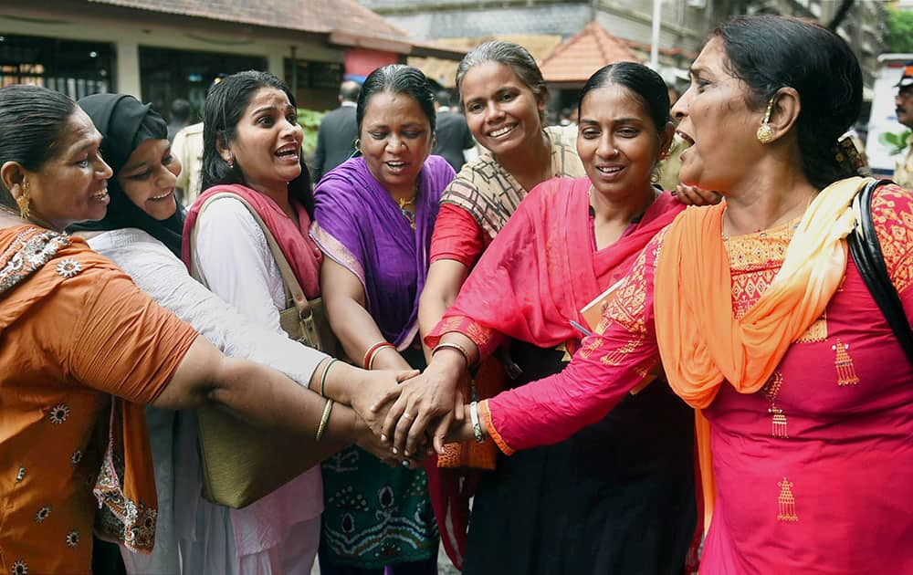 Bharatiya Muslim Mahila Andolan members celebrate after the Mumbai High Court has ruled that women can enter the inner sanctum of the Haji Ali Dargah in Mumbai