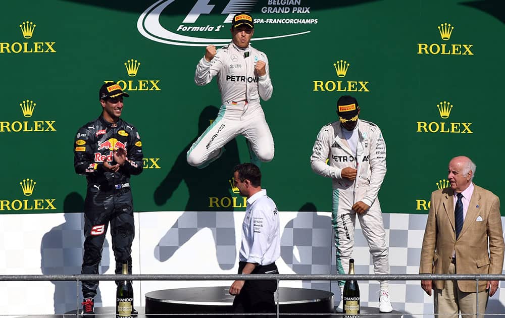 Mercedes driver Nico Rosberg of Germany winner, celebrates on the podium with Red Bull driver Daniel Ricciardo of Australia place and Mercedes driver Le