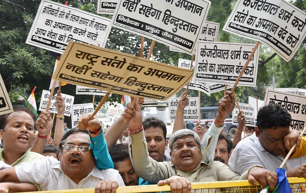 Members of Jain Samaj shout slogans and hold placards to protest against Vishal Dadlani