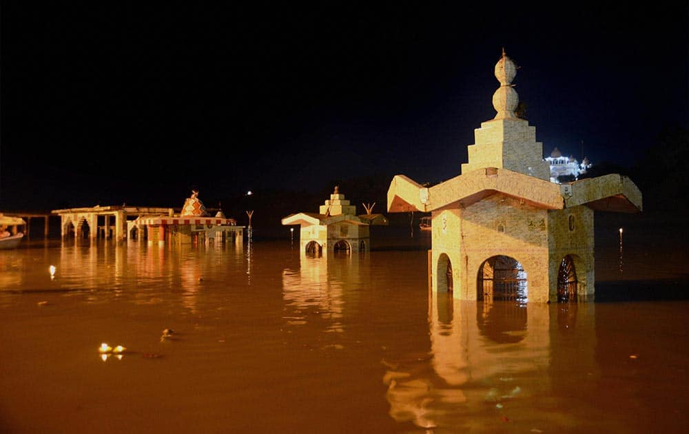Temples submerged in flooded waters of Narmada river Temples submerged in flooded waters of Narmada river