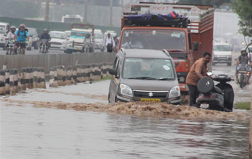 Vehicles wading through a waterlogged road after heavy rains at Delhi- Gurgaon expressway in Gurgaon Vehicles wading through a waterlogged road after heavy rains at Delhi- Gurgaon expressway in Gurgaon