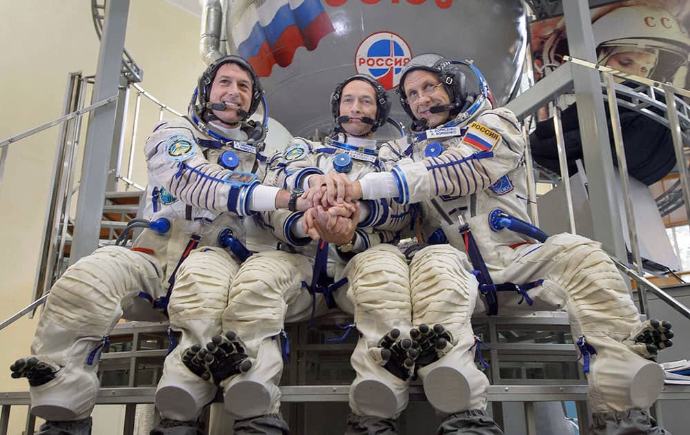 astronaut Shane Kimbrough and Russian cosmonauts Sergey Ryzhikov and Andrey Borisenko pose in front of Russian Soyuz space craft simulator during their final pre-flight training session astronaut Shane Kimbrough and Russian cosmonauts Sergey Ryzhikov and Andrey Borisenko pose in front of Russian Soyuz space craft simulator during their final pre-flight training session