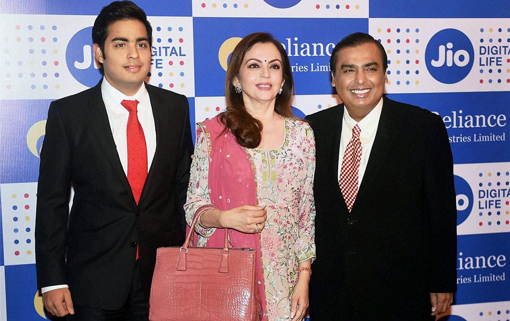 Mukesh Ambani, Chairman, Reliance Industries Ltd. with his wife Nita Ambani and son Akash Ambani arrives for the companys annual general meeting in Mumbai Mukesh Ambani, Chairman, Reliance Industries Ltd. with his wife Nita Ambani and son Akash Ambani arrives for the companys annual general meeting in Mumbai