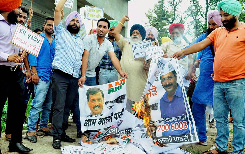 AAP workers burning posters of Delhi CM Arvind Kejriwal AAP workers burning posters of Delhi CM Arvind Kejriwal