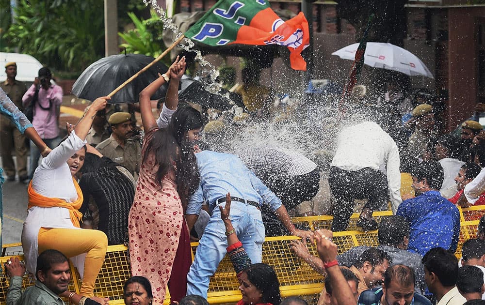Police use water cannons to disperse Delhi BJP members during a protest Police use water cannons to disperse Delhi BJP members during a protest
