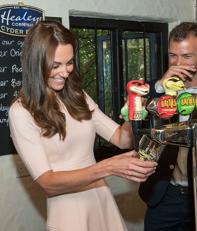 Britains Kate Duchess of Cambridge pours a pint of cider during her visit to Healeys Cornish Cider Farm