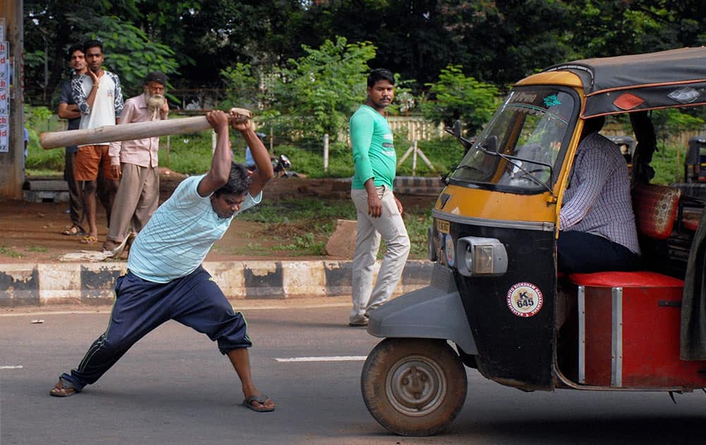 A protester halts an auto during All India Strike called by Left parties and Trade unions in Bhubaneswar