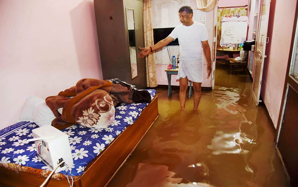 A man surveys his flooded house after heavy downpour in Gaya