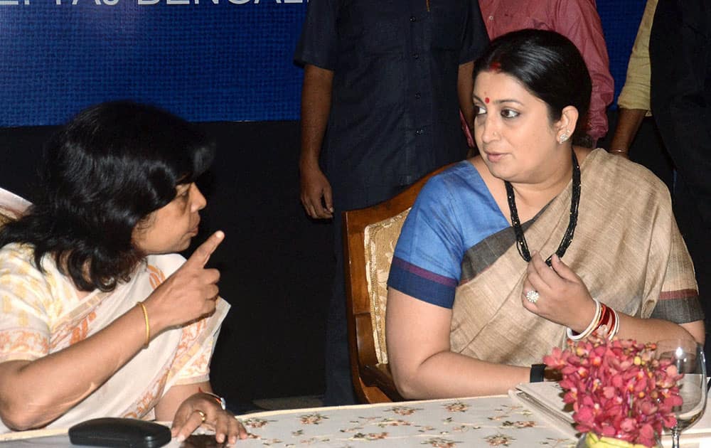 Union Textiles Minister Smriti Irani talks with Textile Secretary Rashmi Verma (L) during inauguration of Jute Sector Shakehoders meeting in Kolkata