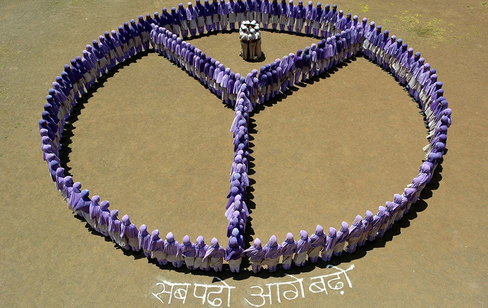 Students of a school form a logo of literacy on the eve of International Literacy Day in Karad