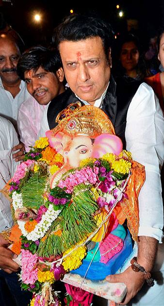 Govinda carries an idol of Lord Ganesh for immersion during Ganesh Utsav celebrations in Mumbai