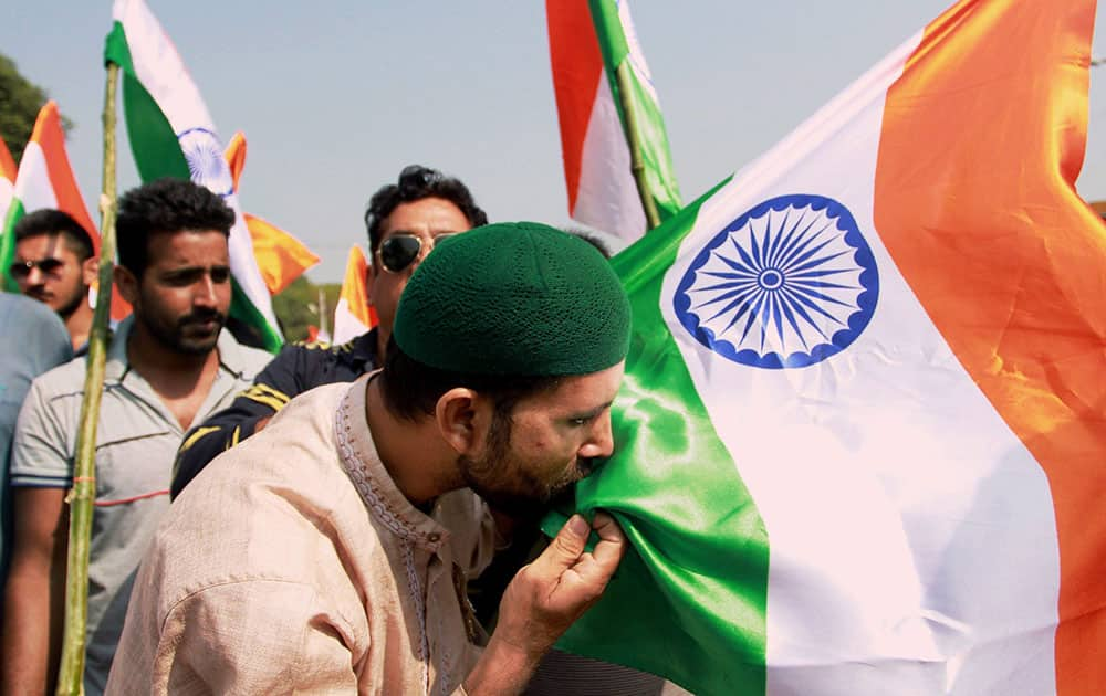 A member of the Jammu Citizens Forum kisses the Tricolour during the Tiranga Yatra in support of the Indian Army and security forces, in Jammu