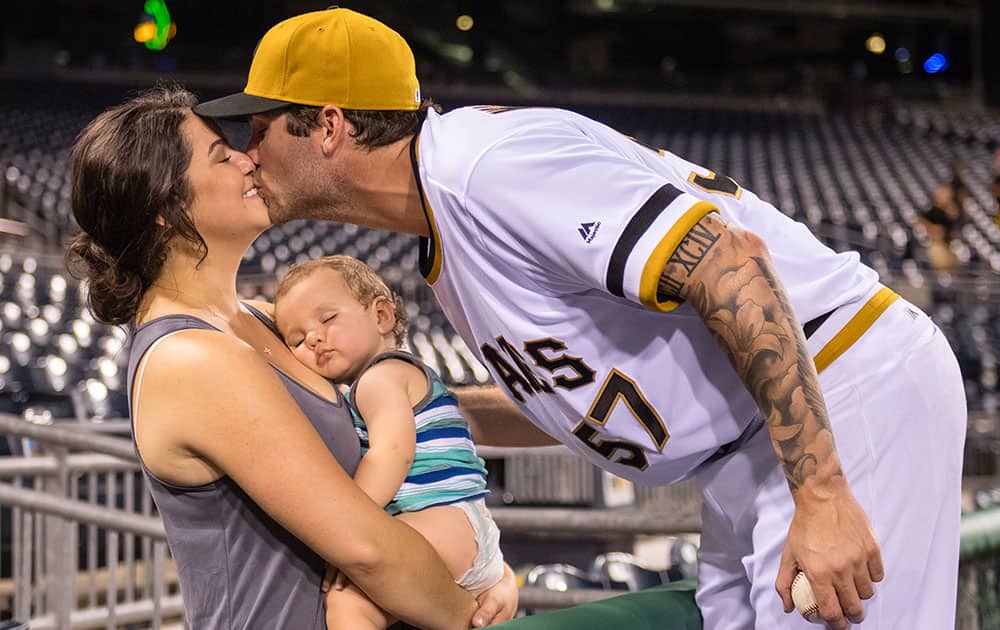 Trevor Williams #57 of the Pittsburgh Pirates kisses his wife Jackie Williams after getting his first Major League win
