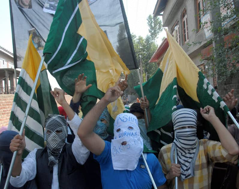 Masked youth carrying flags and shouts sloags