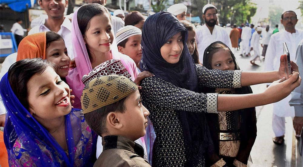 Children take selfies during Eid al-Adha