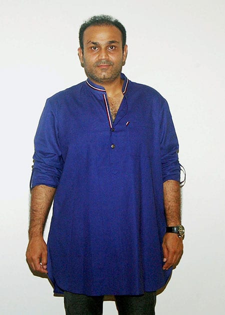 Former cricketer Virendra Sehwag showcases a Khadi attire at a Khadi store in New Delhi
