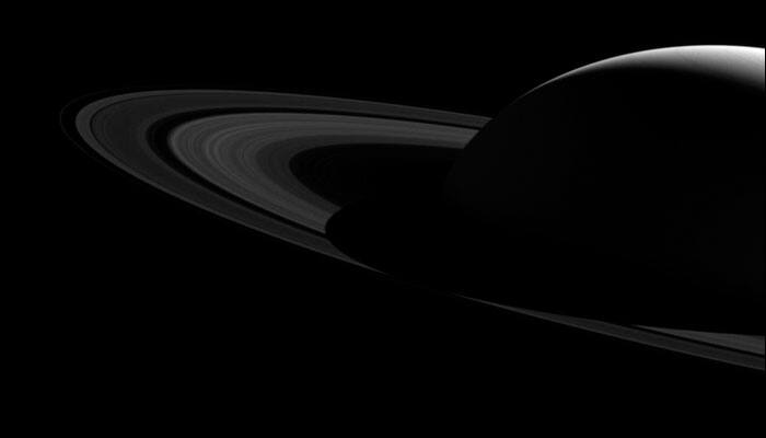 Behind the shadows: NASA&#039;s Cassini captures Saturn&#039;s silhouette over its rings in a stunning image!