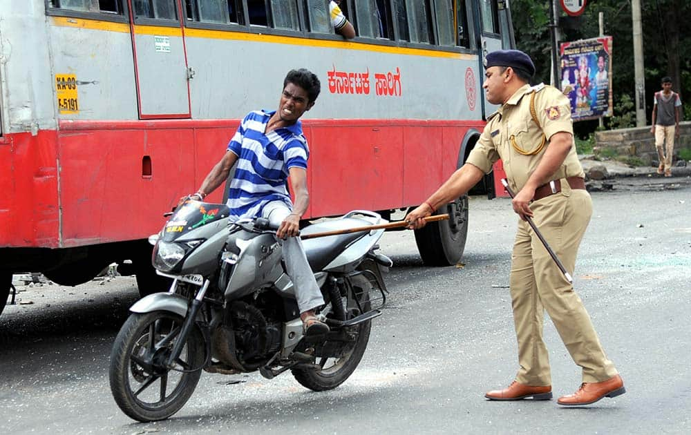 A police man charges a miscreant riding motorcycle