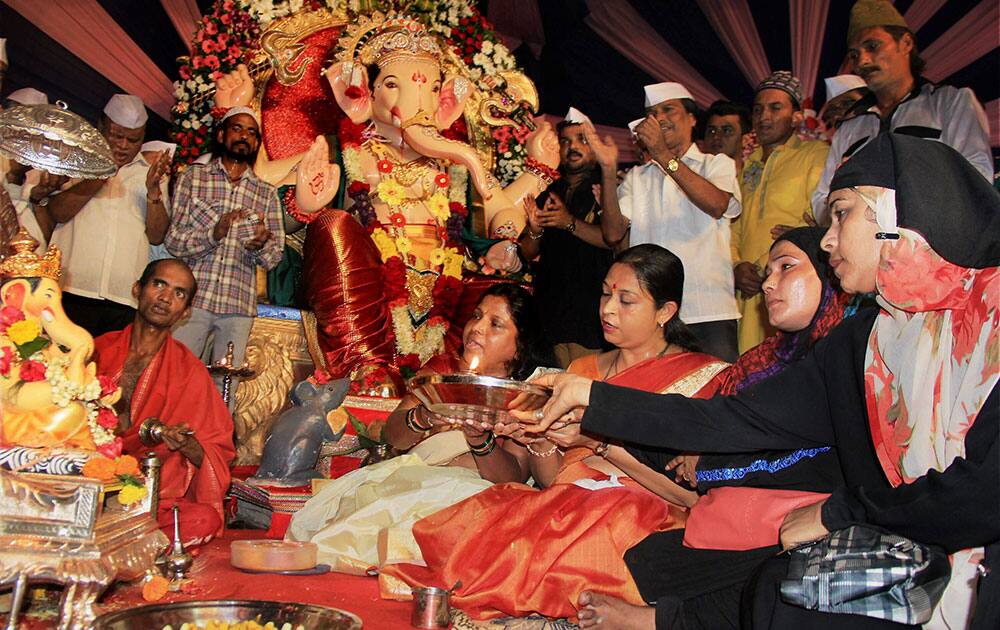 Muslim women perform aarti at a Ganesh Pandal during Ganeshotsav in Mumbai